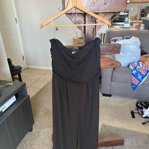 Brand new. Never worn! Black pant jumpsuit. Strapless with a fake gold necklace!